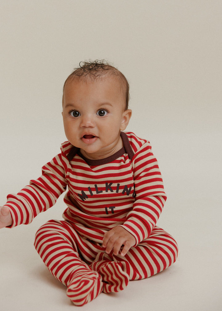 Baby wearing Claude & Co crimson stripe onesie