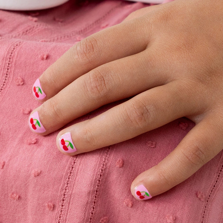 Rex cherry nail stickers applied to children's fingernails